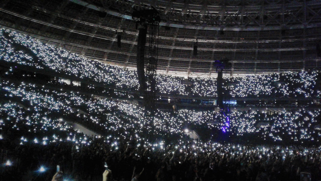 Concert audience holding up phone lights during a live show